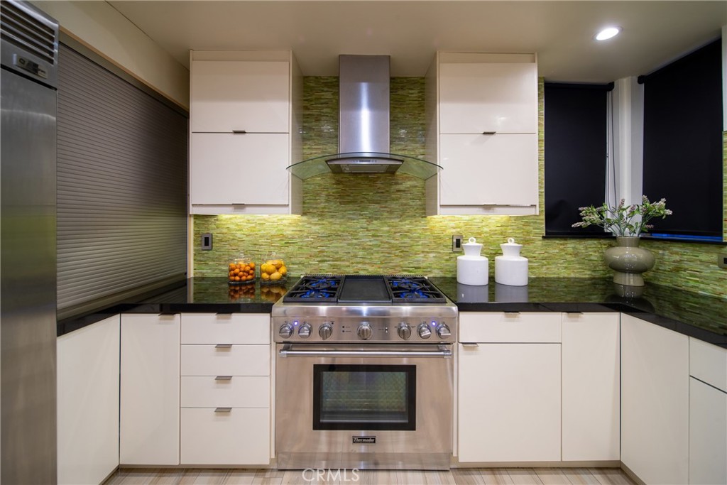 4557 Haskell Avenue, Unit 301 Encino, CA 91436 - Photo 8 of 40 a kitchen with stainless steel appliances granite countertop a stove and a sink