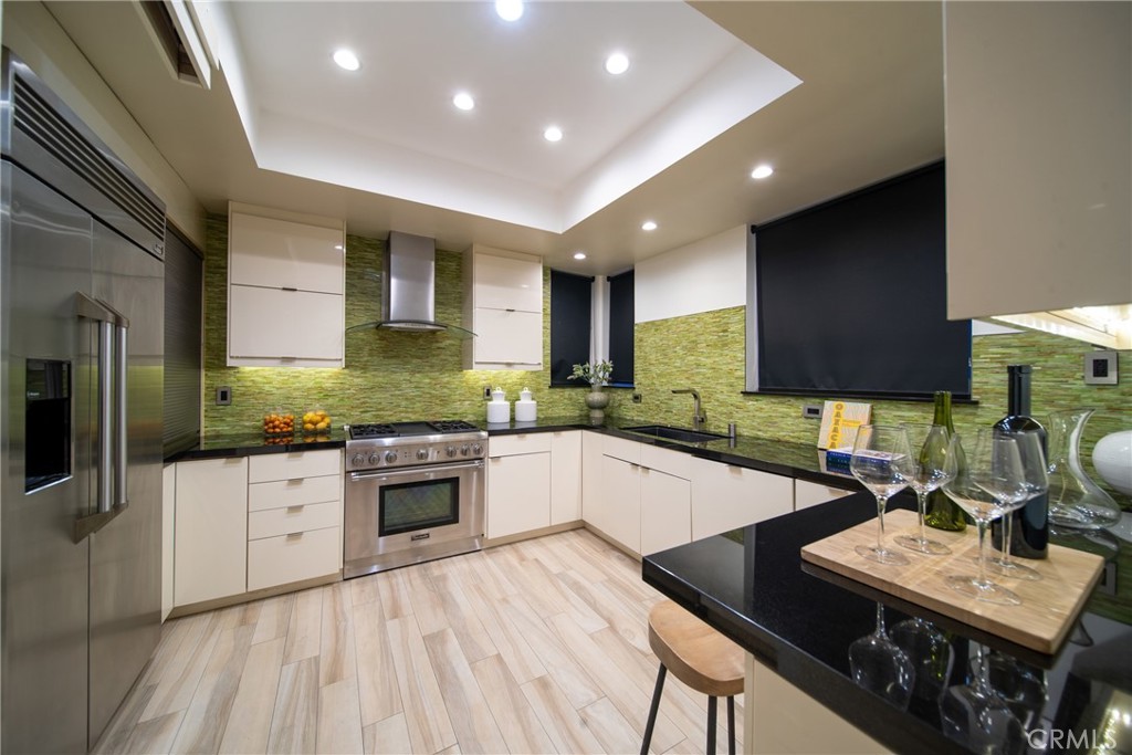 4557 Haskell Avenue, Unit 301 Encino, CA 91436 - Photo 9 of 40 a kitchen with stainless steel appliances granite countertop a sink dishwasher stove refrigerator and cabinets