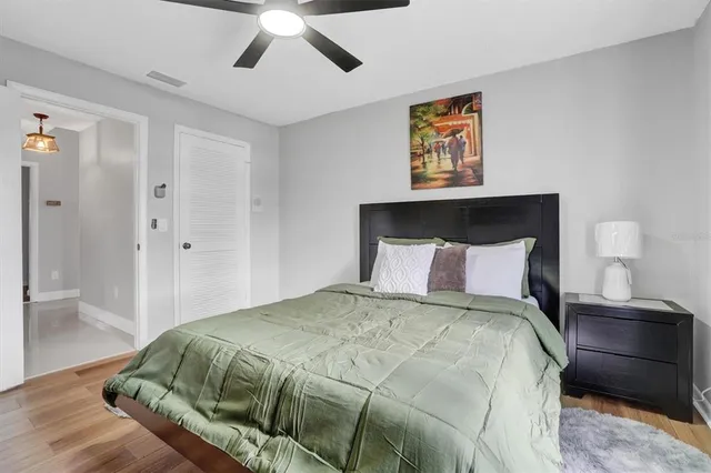 a bedroom with a large bed and a painting on the wall