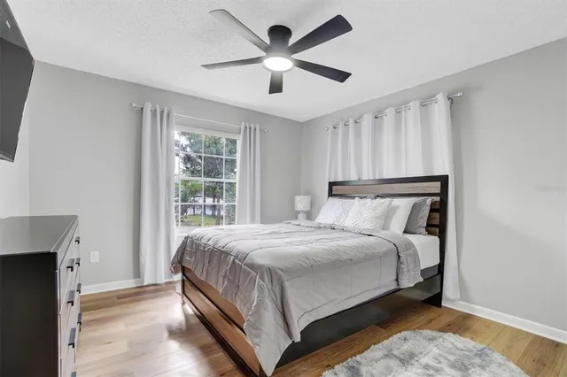 a bedroom with a large bed and a large window