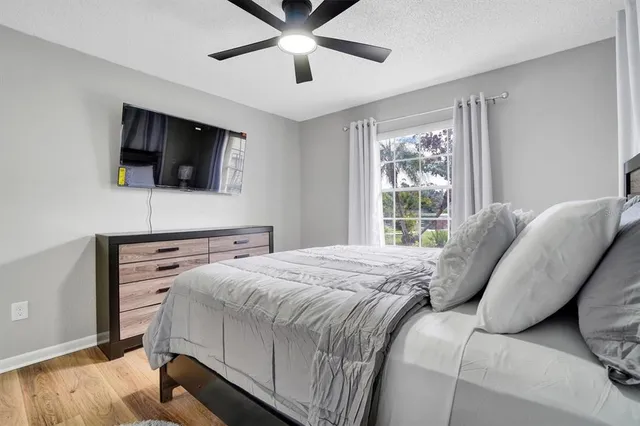 a bedroom with a bed and a flat screen tv