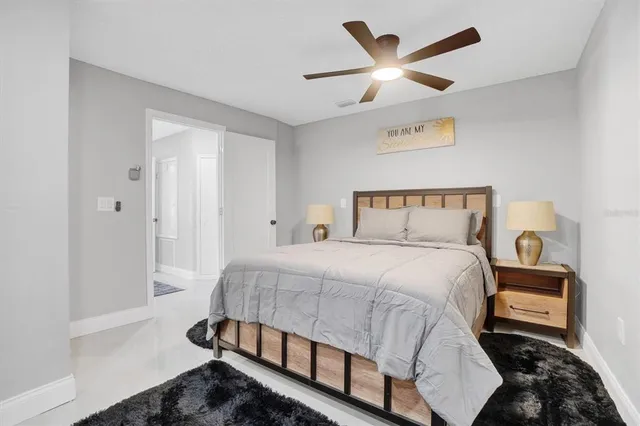 a bedroom with a bed and a ceiling fan
