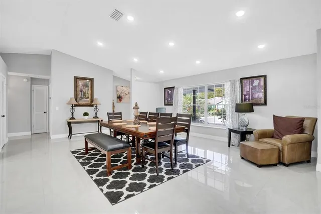 a living room with furniture a rug and a table