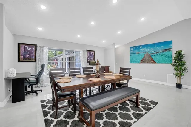 a living room with furniture a piano and a flat screen tv