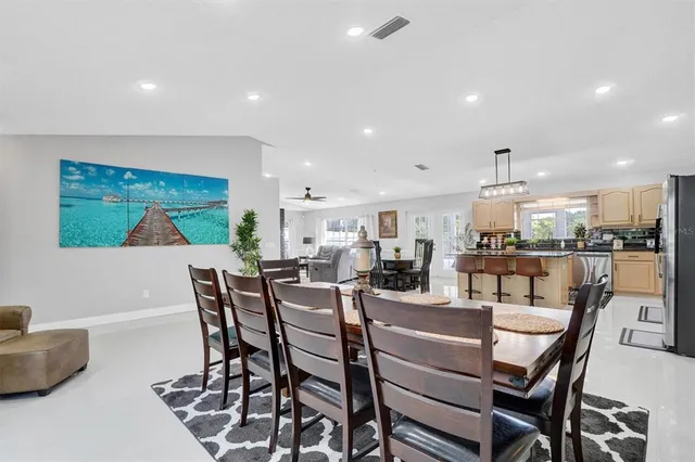 a dining room with furniture and a floor to ceiling window