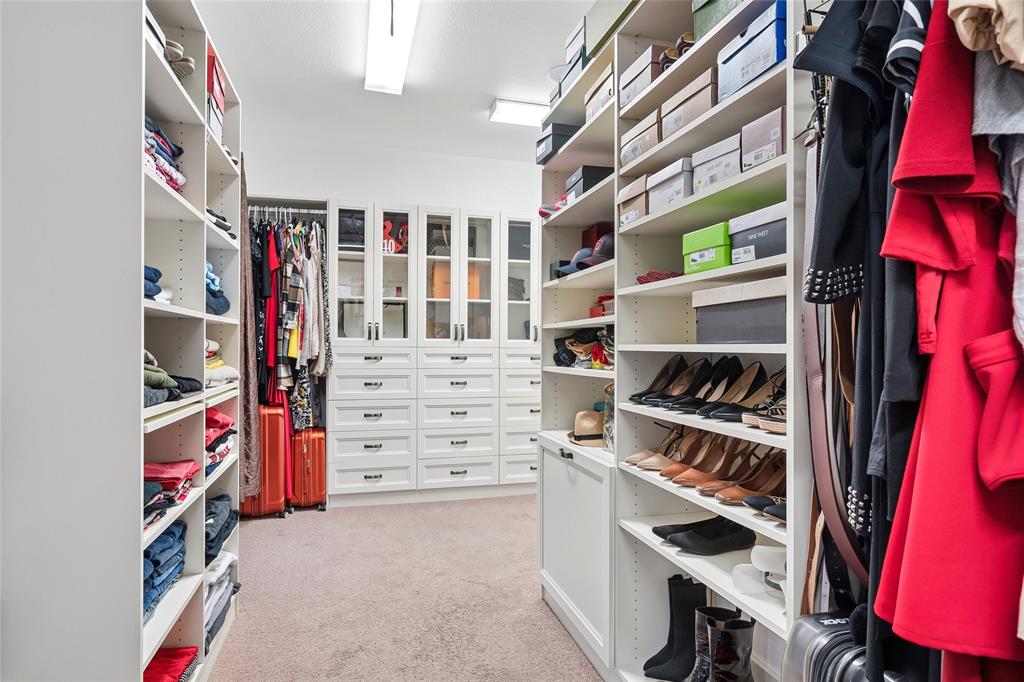 835 Rockingham Drive Irving, TX 75063 - Photo 18 of 27 a view of walk in closet with clothes and shoes