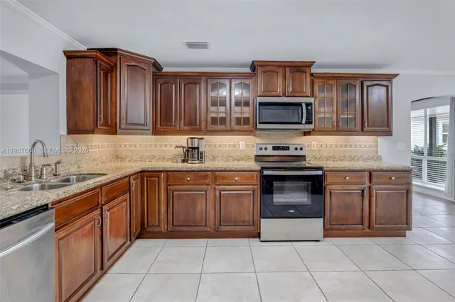 a bathroom with a granite countertop sink mirror and shower