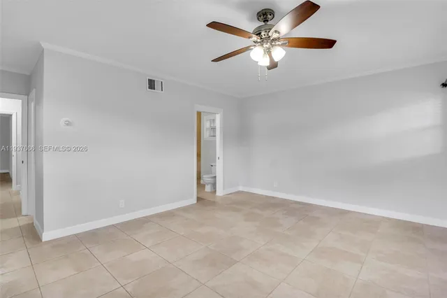 a view of an empty room with a ceiling fan