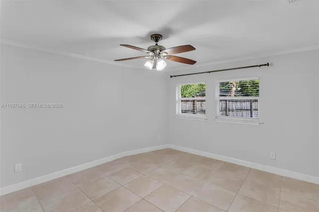 a front view of a house with a garden and yard