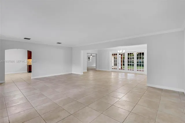 an empty room with fireplace and windows