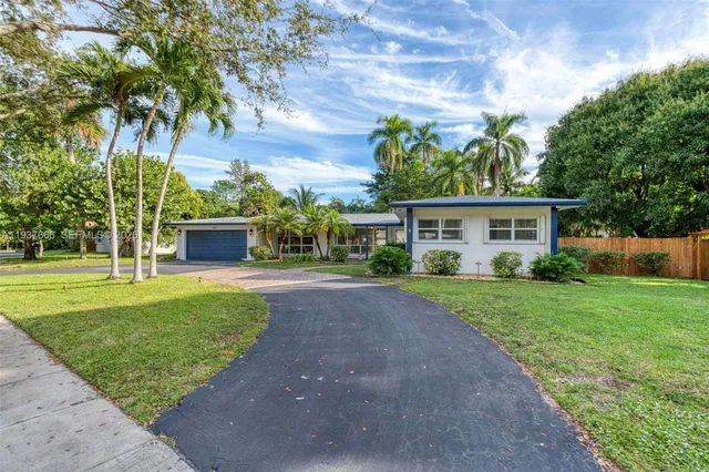 an aerial view of residential house with outdoor space and swimming pool