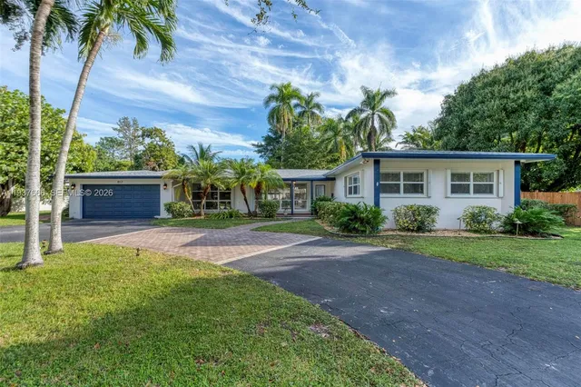 an aerial view of a house with a yard and garden