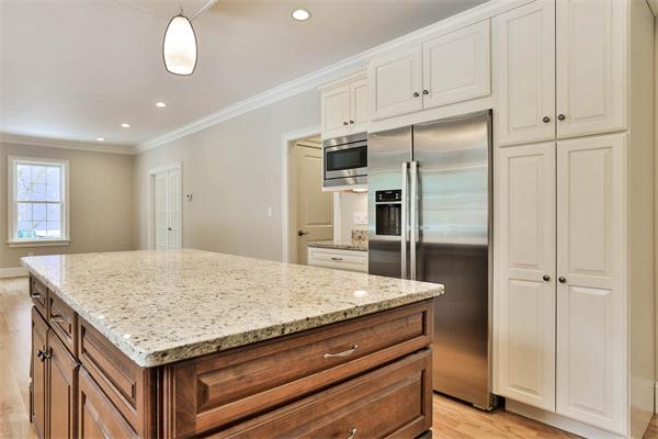 7 Davis Road Bedford, MA 01730 - Photo 11 of 30 a kitchen with granite countertop cabinets and refrigerator