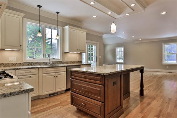 7 Davis Road Bedford, MA 01730 - Photo 12 of 30 a kitchen with kitchen island granite countertop a stove a sink a refrigerator and wooden floor