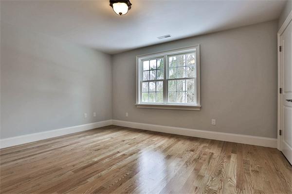 7 Davis Road Bedford, MA 01730 - Photo 17 of 30 an empty room with wooden floor and windows