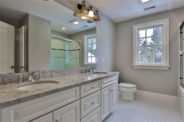 7 Davis Road Bedford, MA 01730 - Photo 18 of 30 a bathroom with a granite countertop sink a toilet and mirror