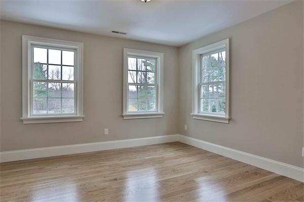 7 Davis Road Bedford, MA 01730 - Photo 19 of 30 a view of an empty room with wooden floor and a window