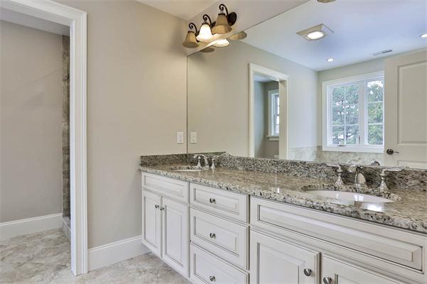 7 Davis Road Bedford, MA 01730 - Photo 21 of 30 a bathroom with a granite countertop double vanity sink a window and a mirror
