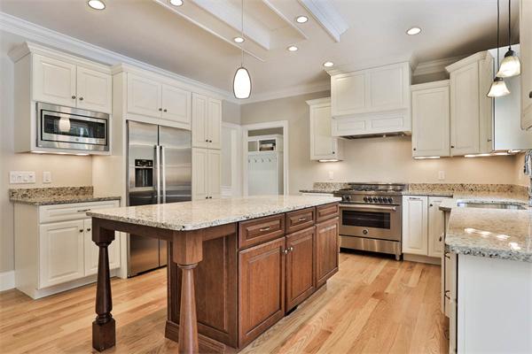7 Davis Road Bedford, MA 01730 - Photo 8 of 30 a kitchen with stainless steel appliances granite countertop a stove top oven a sink and dishwasher a refrigerator with wooden floor