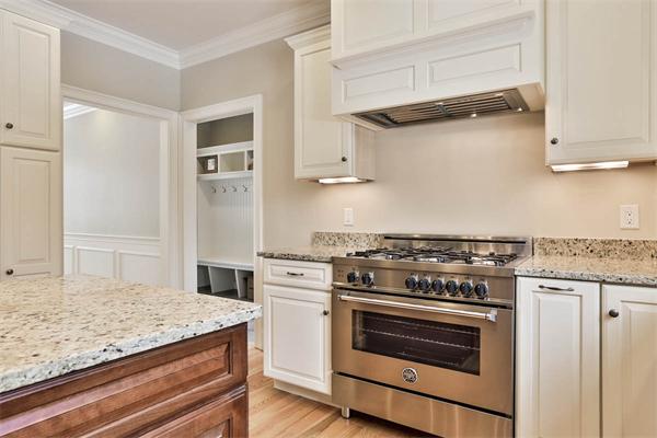 7 Davis Road Bedford, MA 01730 - Photo 10 of 30 a kitchen with cabinets appliances and wooden floor
