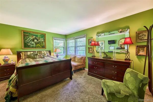 a bedroom with a bed and a dresser in it