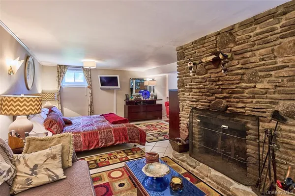 a bedroom with bed and a lamp on dresser