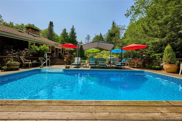a view of a house with swimming pool and sitting area