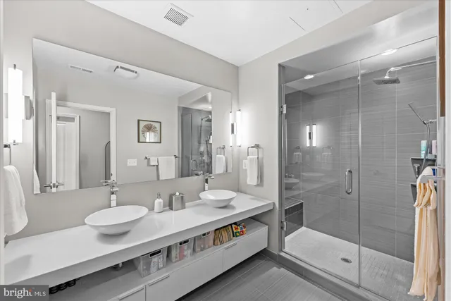 a bathroom with a double vanity sink and mirror
