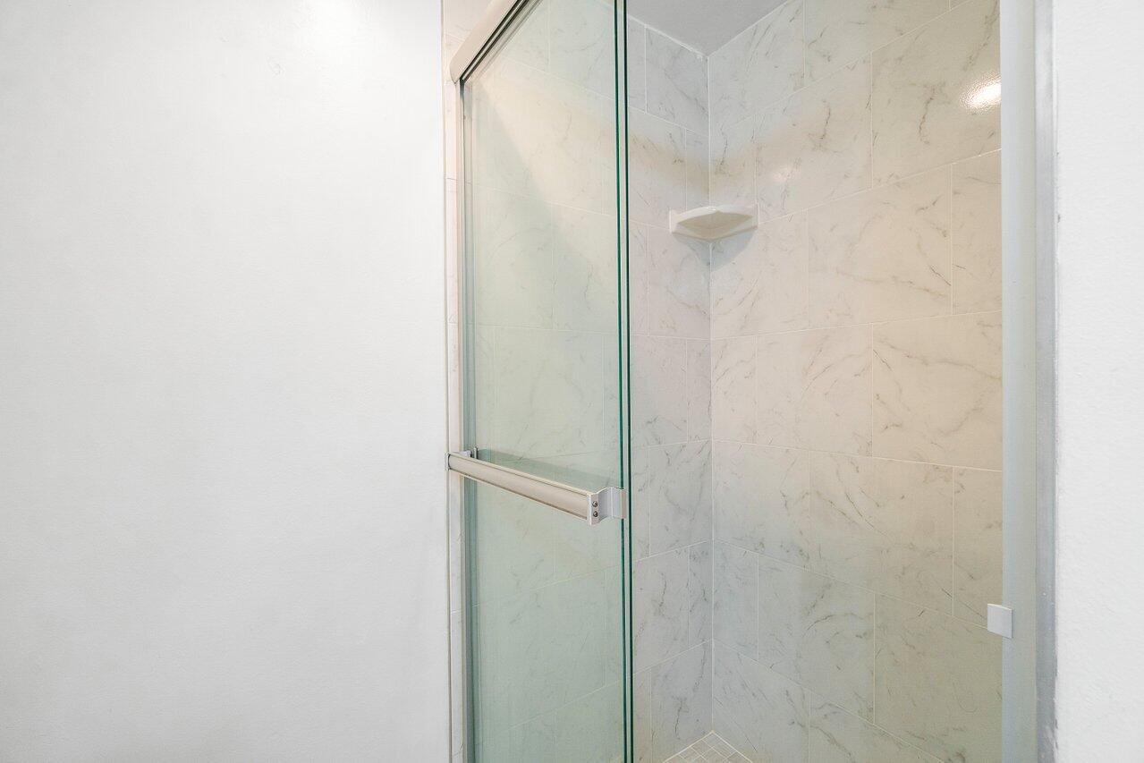 250 Northeast 20th Street, Unit 2250 Boca Raton, FL 33431 - Photo 15 of 22 a bathroom with a glass shower door