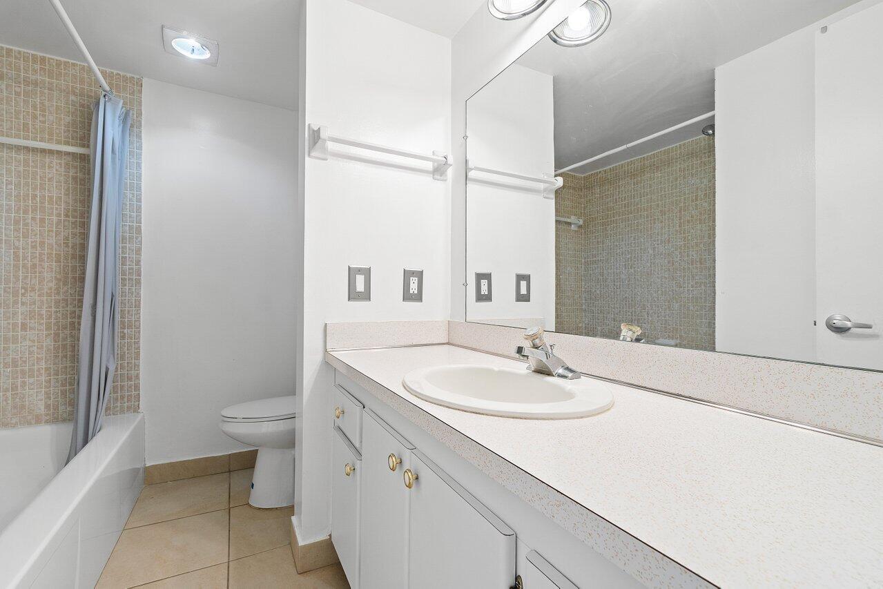 250 Northeast 20th Street, Unit 2250 Boca Raton, FL 33431 - Photo 16 of 22 a bathroom with a sink a toilet and shower