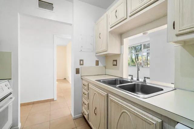 a kitchen with granite countertop white cabinets and sink