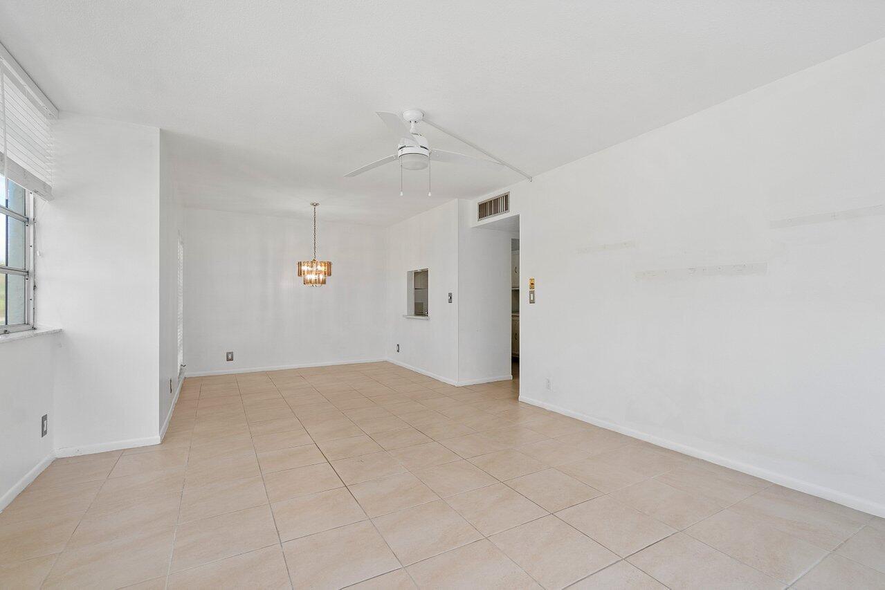 250 Northeast 20th Street, Unit 2250 Boca Raton, FL 33431 - Photo 10 of 22 an empty room with an entryway and chandelier