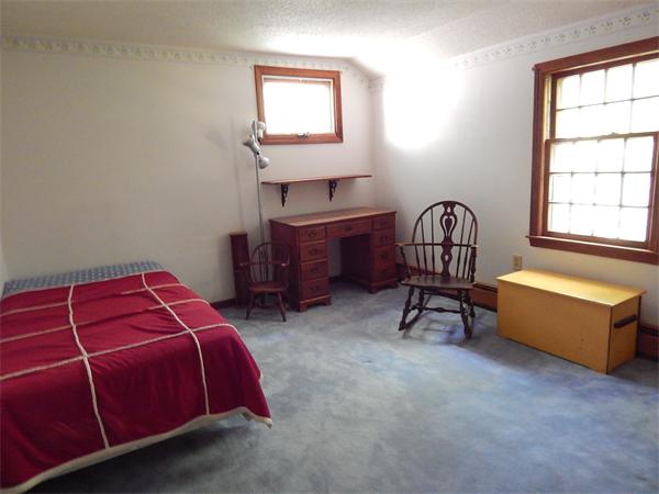5 Wamsutta Road Scituate, MA 02066 - Photo 9 of 10 a bedroom with a bed and a window