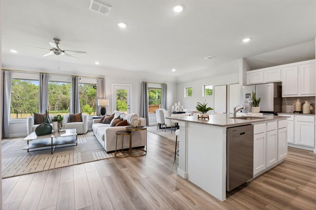1932 Callington Way Forney, TX 75126 - Photo 25 of 25 a large living room with stainless steel appliances granite countertop furniture a large window with wooden floor