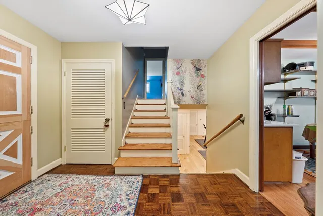a view of entryway with furniture and stairs