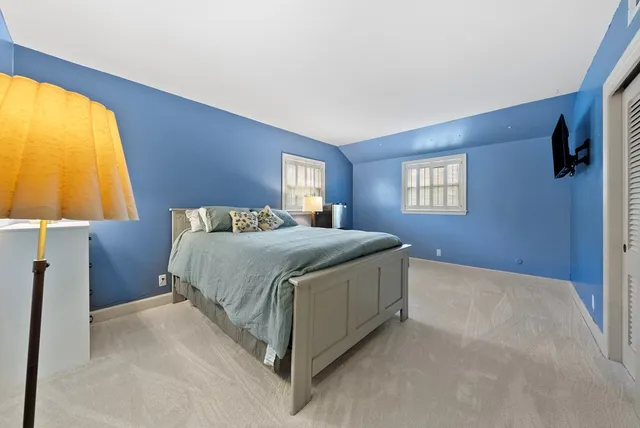 a bedroom with a bed and a lamp