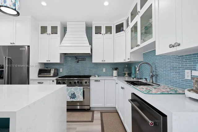 a kitchen with a sink stainless steel appliances and cabinets