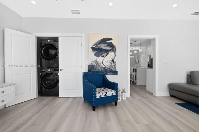 a living room with furniture a potted plant and a table