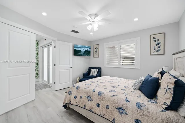 a view of a patio with couches table and chairs and potted plants