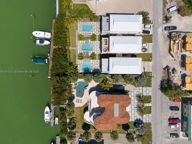 a front view of a residential apartment building with a yard
