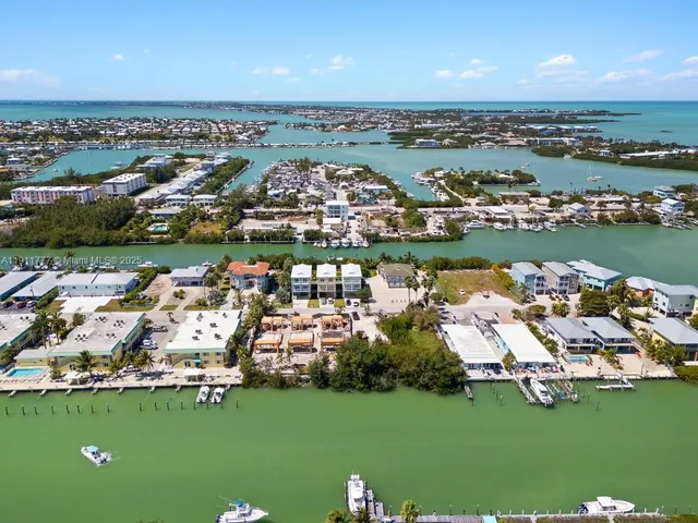 a porch with a bench next to a yard