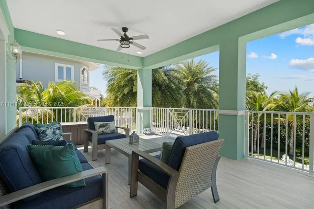 a living room with fireplace furniture and a large window