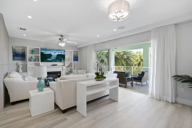 a kitchen with stainless steel appliances kitchen island granite countertop a table chairs and a refrigerator