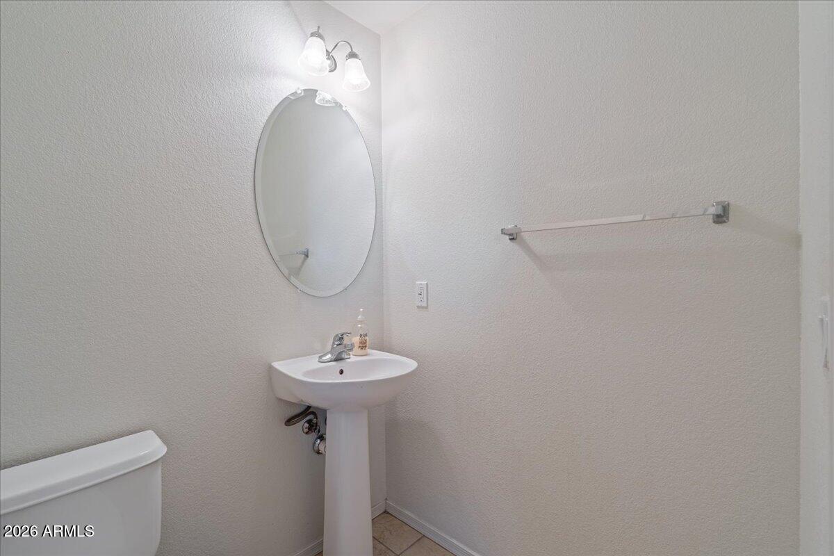 1255 South Rialto, Unit 106 Mesa, AZ 85209 - Photo 23 of 32 a bathroom with a sink a toilet and a mirror