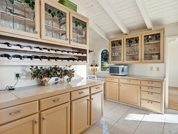 a kitchen with cabinets and window