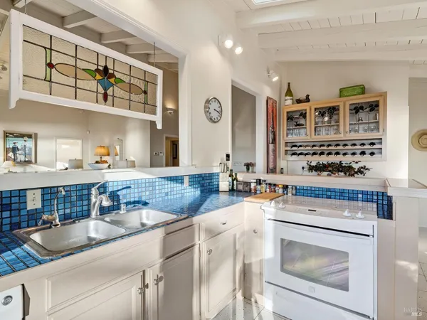 a kitchen with stainless steel appliances granite countertop a sink stove and cabinets
