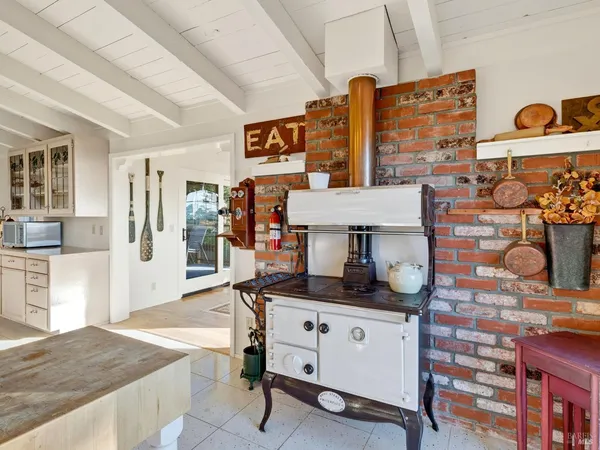a kitchen with stainless steel appliances granite countertop a stove and cabinets