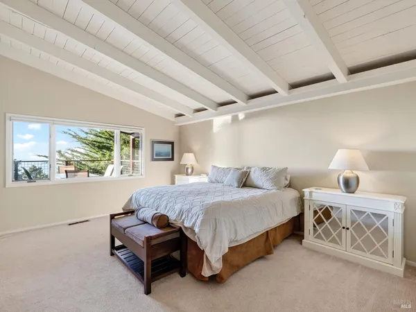 a spacious bedroom with a bed and a window