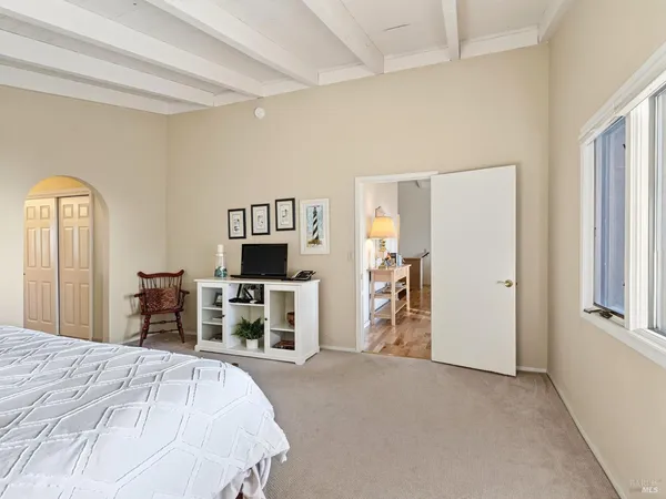 a bedroom with furniture and a flat screen tv