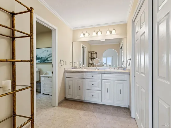 a spacious bathroom with a double vanity sink and a mirror